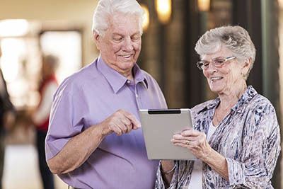 man and woman talking and looking at a clipboard