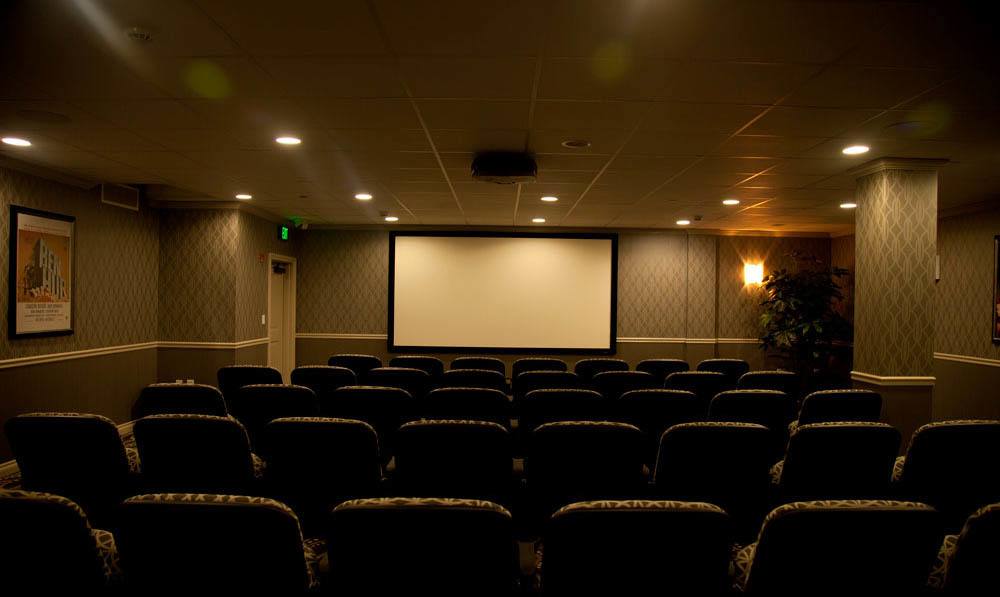 Empty seats in front of a large screen in the Cohawney Cinema at The Ambassador