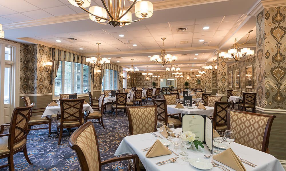 Elegant table and chair setup in the Heathcote Dining Room at The Ambassador