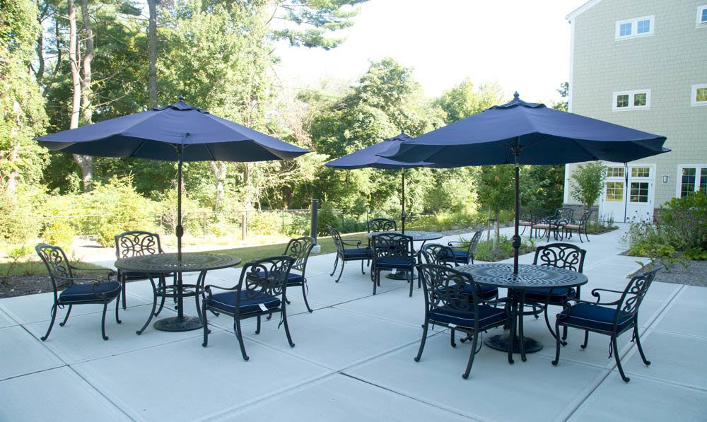 Tables, chairs and umberalls set on the patio outside the Five Corners Bistro at The Ambassador
