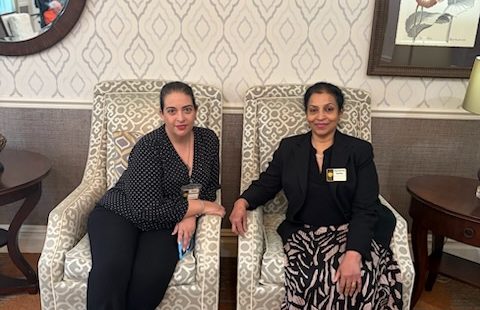 two women sitting on armchairs side by side